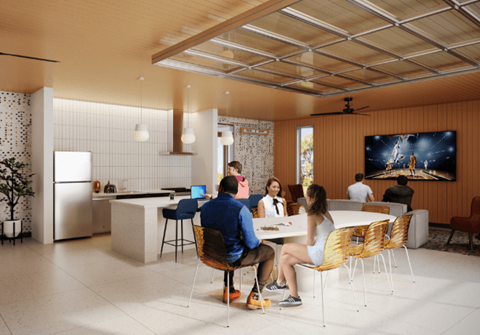 a group of people sitting around a table in an open kitchen and living room